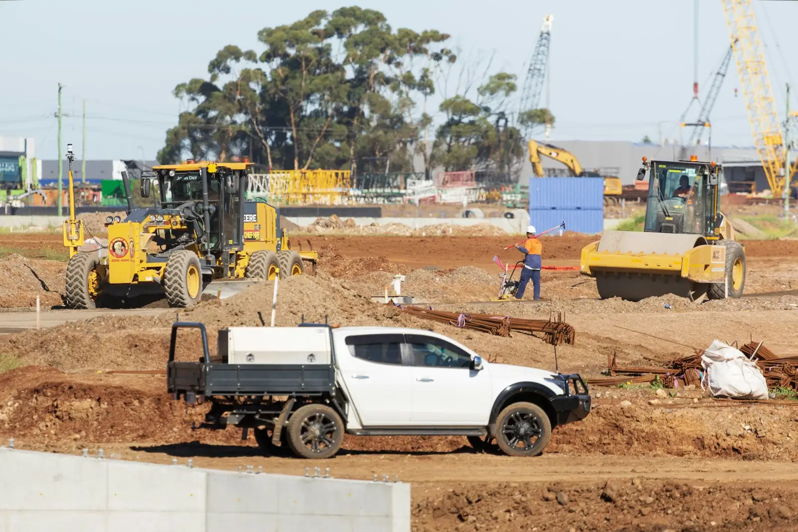 White ute on an Australian construction site with machinery